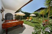 Garden with sunbathing area and pleasant seating at Pension Haller